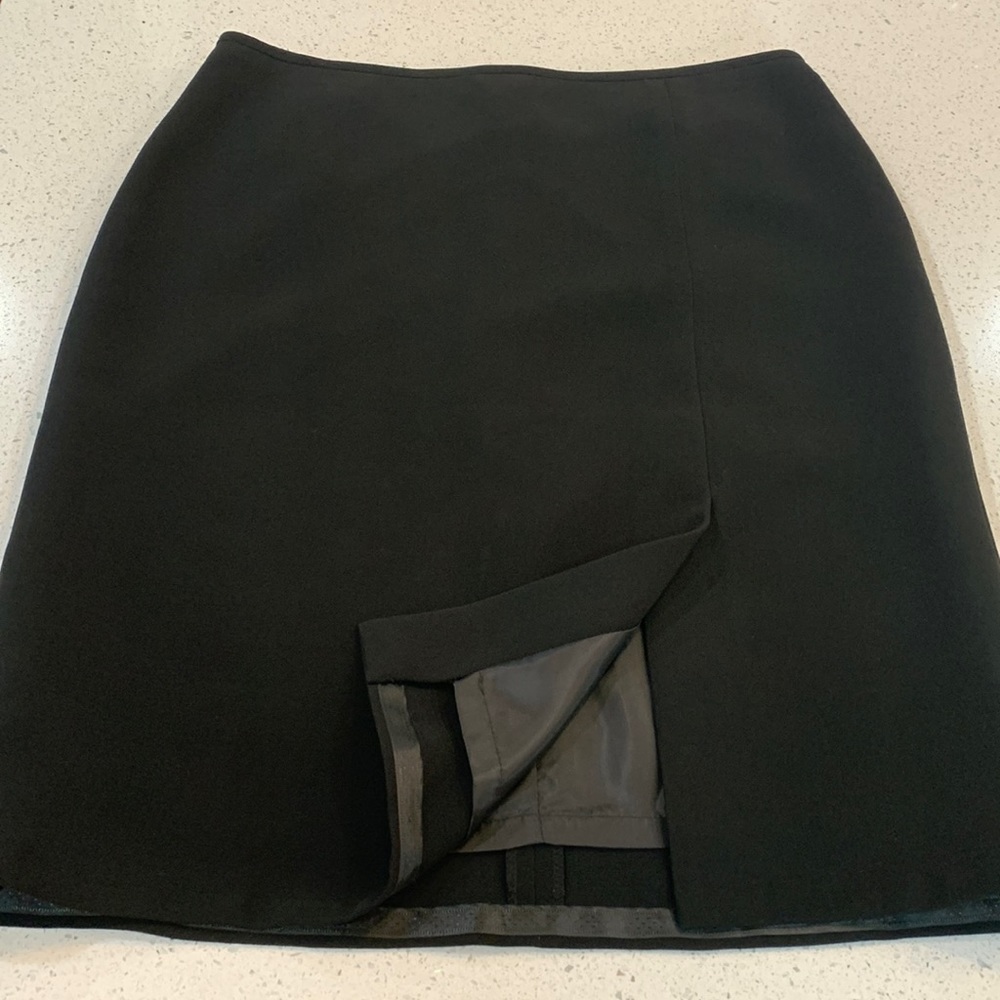 Size 12 Ladies lined skirt. Has short slit in front as shown in the photo